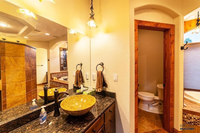 bathroom featuring tile patterned flooring, a shower, vanity, and toilet