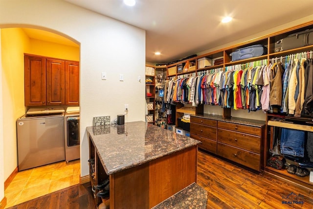 spacious closet featuring dark hardwood / wood-style flooring and washer and dryer