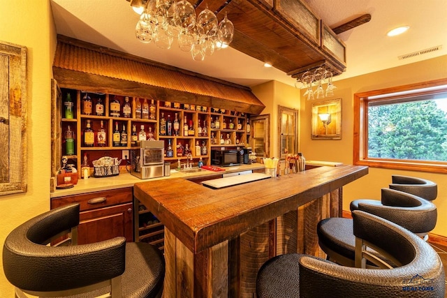 bar with butcher block countertops and sink