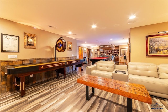 interior space featuring wood-type flooring, bar area, and billiards