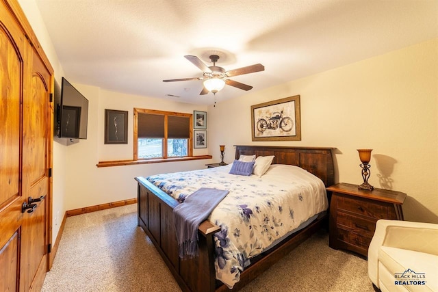 carpeted bedroom with a textured ceiling and ceiling fan