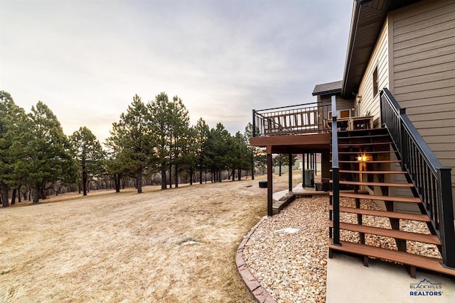 view of yard featuring a wooden deck and central AC unit