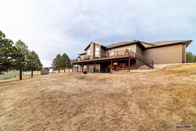 back of house with a yard and a wooden deck