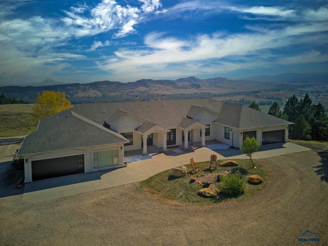 view of front of house with a mountain view and a garage