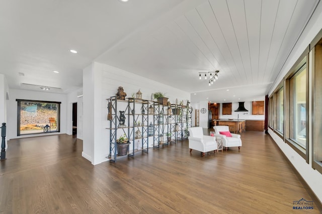 unfurnished living room featuring an inviting chandelier and hardwood / wood-style floors