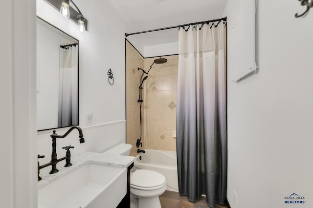 full bathroom with vanity, shower / bath combo with shower curtain, and toilet