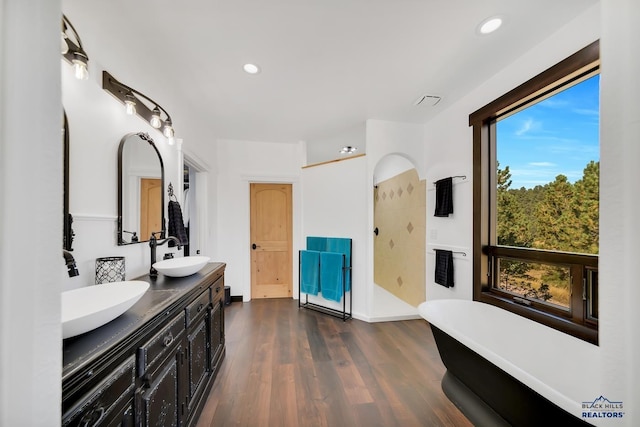 bathroom with vanity, separate shower and tub, and wood-type flooring