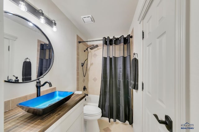 full bathroom featuring vanity, tile patterned flooring, toilet, and shower / bathtub combination with curtain