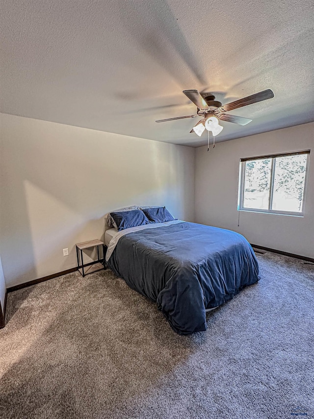 bedroom featuring carpet flooring, a textured ceiling, and ceiling fan