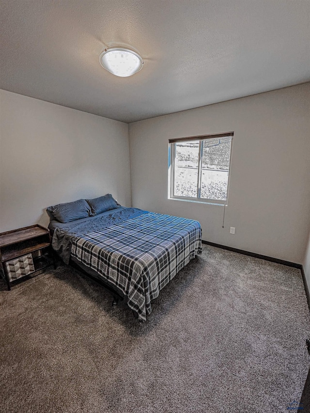 bedroom with a textured ceiling and carpet flooring