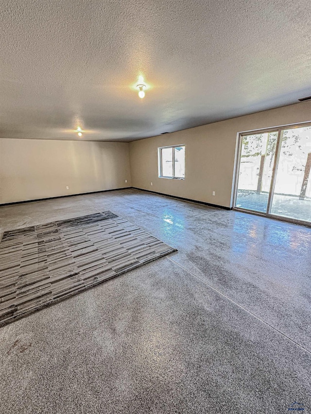 spare room with a textured ceiling and plenty of natural light