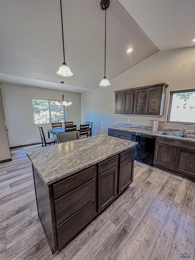 kitchen featuring lofted ceiling, dark brown cabinets, black dishwasher, and a healthy amount of sunlight