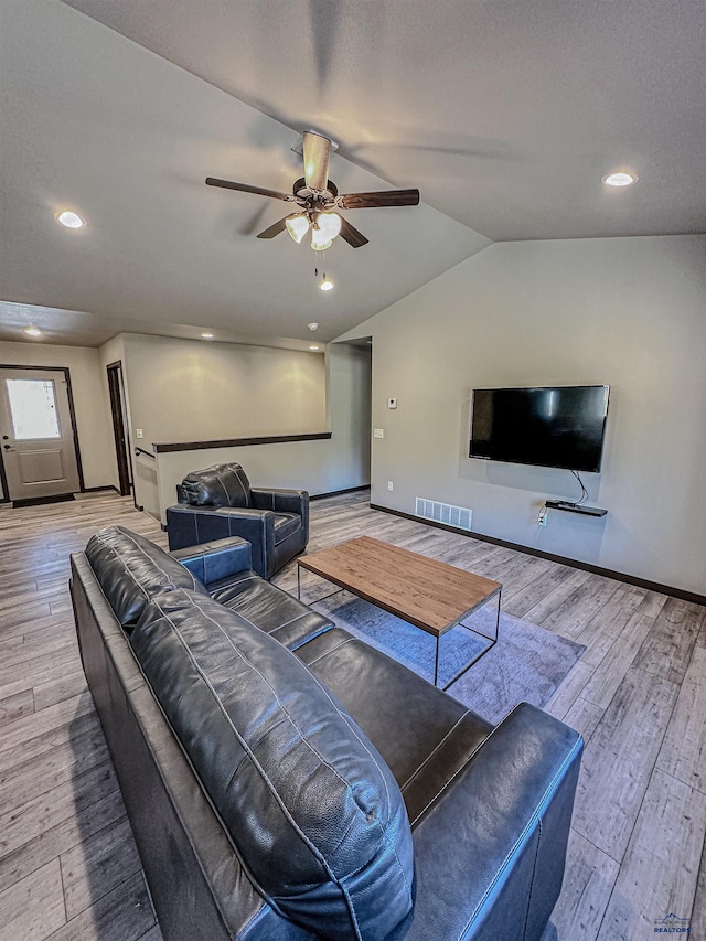 living room with lofted ceiling, ceiling fan, and hardwood / wood-style floors