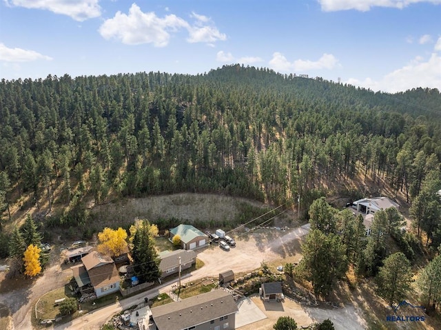 drone / aerial view featuring a view of trees
