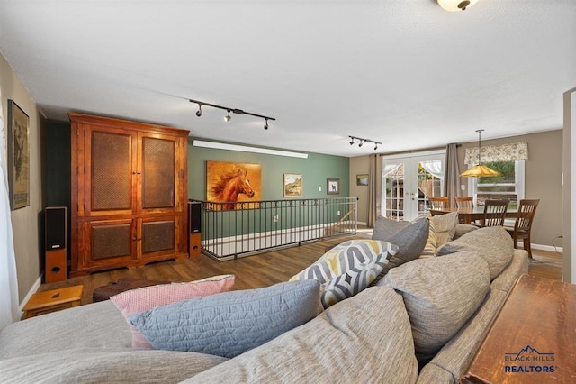 living room with french doors, wood-type flooring, and rail lighting