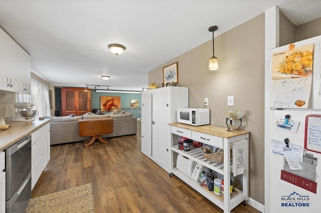 kitchen with white cabinets, light countertops, dark wood-style floors, and white appliances