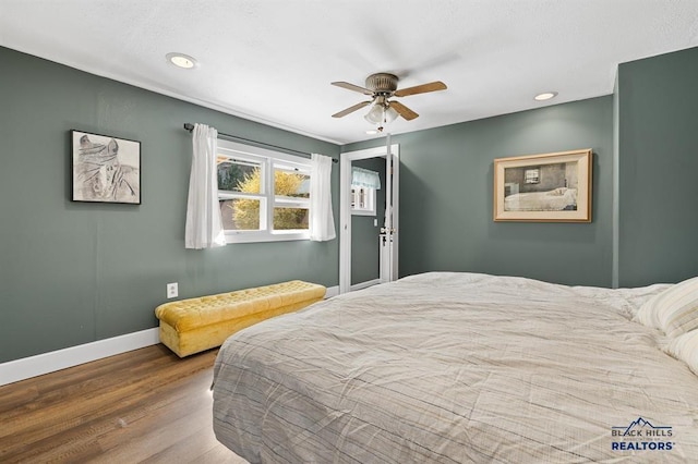 bedroom with recessed lighting, wood finished floors, a ceiling fan, and baseboards