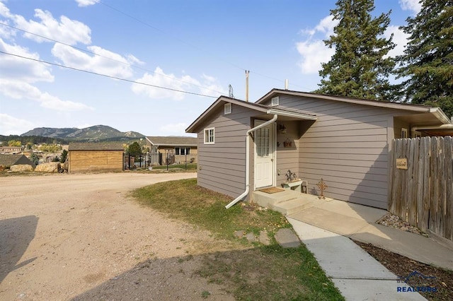 view of front of house with fence and a mountain view