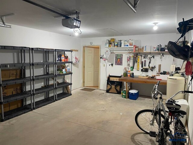 garage with a workshop area and a garage door opener