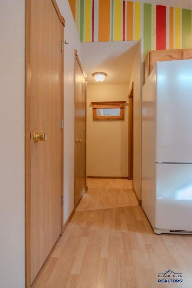 hall with light hardwood / wood-style flooring