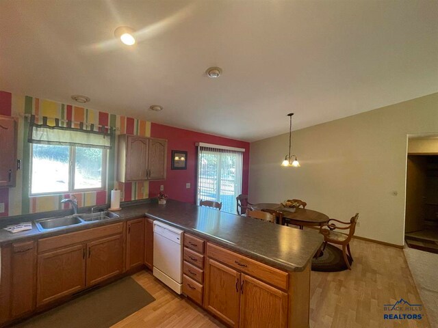 kitchen featuring light hardwood / wood-style floors, kitchen peninsula, lofted ceiling, white dishwasher, and sink