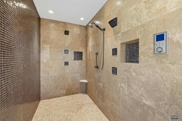 bathroom with a tile shower