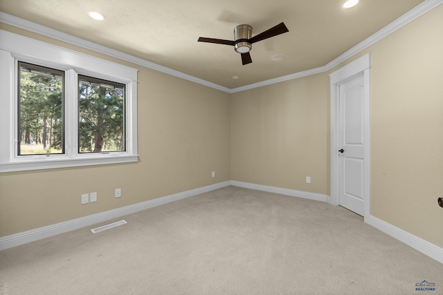 carpeted empty room with ceiling fan and ornamental molding