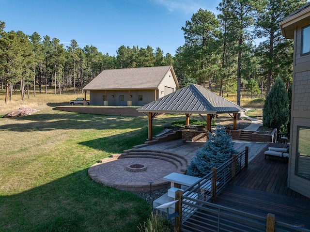 view of yard featuring a patio, an outdoor fire pit, and a wooden deck