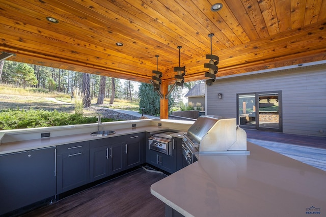 view of patio / terrace with a wooden deck, sink, and a grill