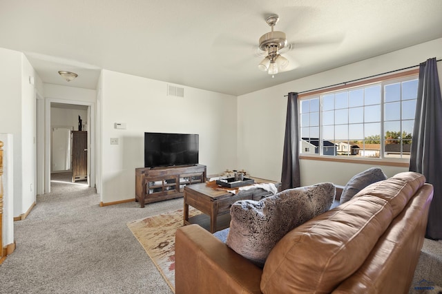 carpeted living room with ceiling fan