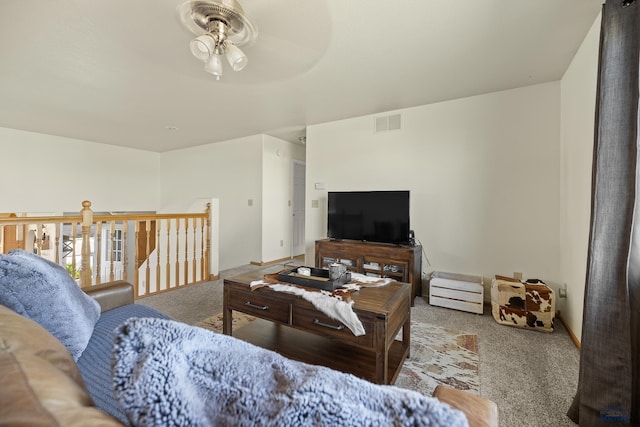 carpeted living room with ceiling fan