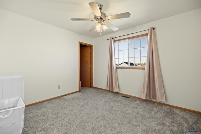 spare room featuring carpet and ceiling fan