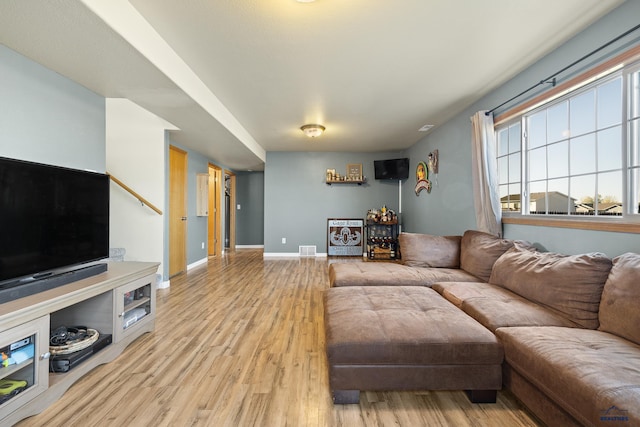 living room with light hardwood / wood-style flooring