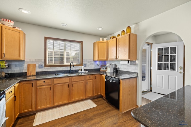 kitchen with sink, dark wood-type flooring, dishwasher, and backsplash