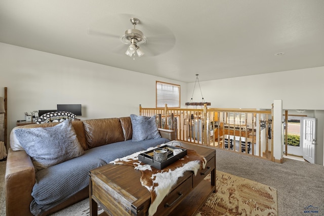 living room with carpet and ceiling fan with notable chandelier