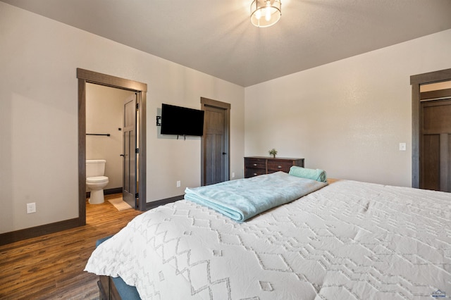 bedroom featuring hardwood / wood-style floors and ensuite bathroom