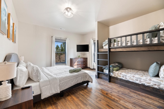 bedroom with dark hardwood / wood-style floors