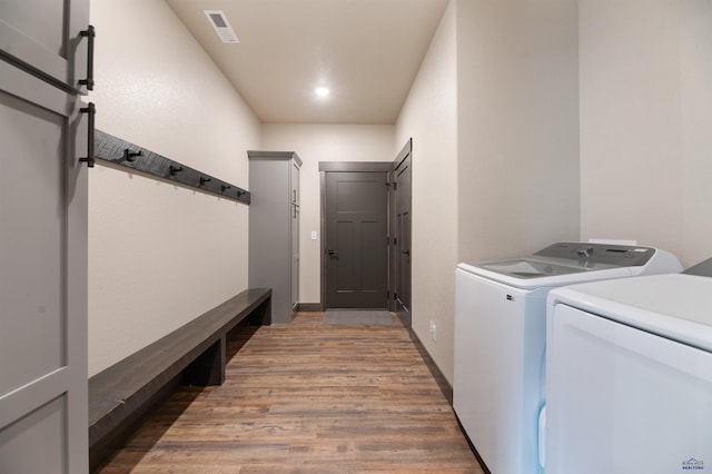 washroom with dark hardwood / wood-style floors and separate washer and dryer