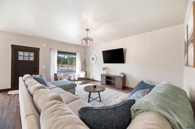 living room with a chandelier and hardwood / wood-style flooring