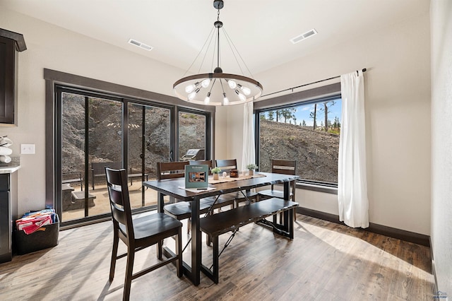 dining area with a chandelier and wood-type flooring