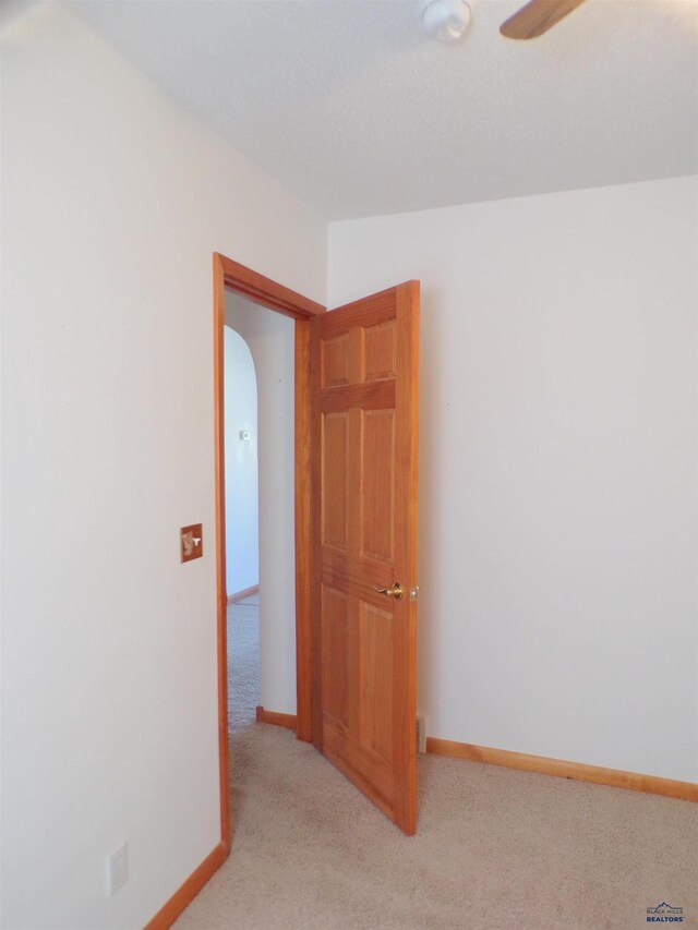 415 Spark St, Lead, SD 57754 - spare room with light colored carpet, baseboards, arched walkways, and ceiling fan