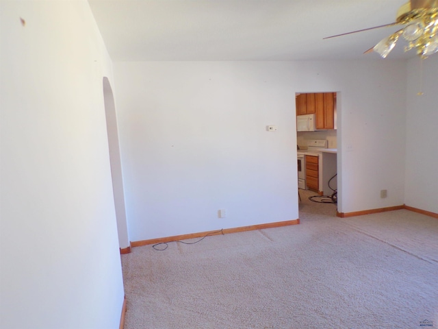 carpeted empty room featuring ceiling fan