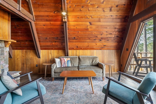 living area featuring wood ceiling, vaulted ceiling, and wooden walls