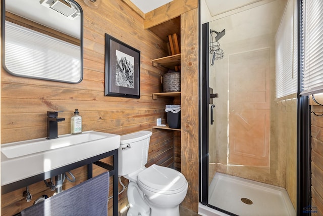 bathroom with toilet, wood walls, walk in shower, and sink