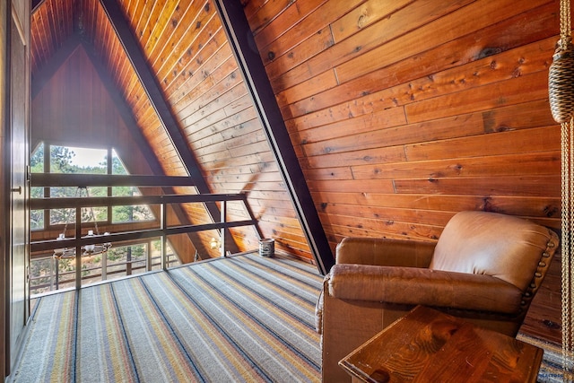 sitting room with wooden walls, wooden ceiling, and vaulted ceiling with beams