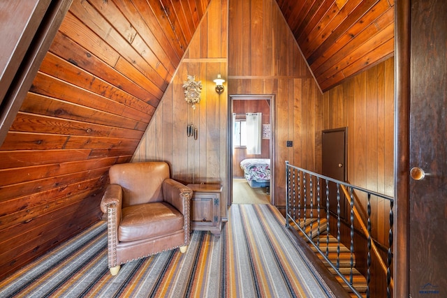 unfurnished room featuring dark carpet, wooden walls, wood ceiling, and high vaulted ceiling