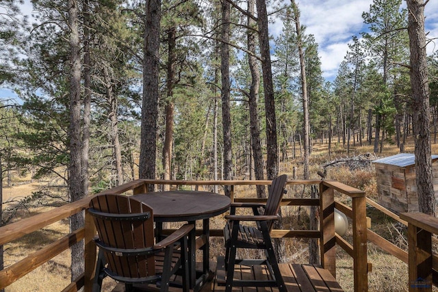 wooden terrace with outdoor dining area