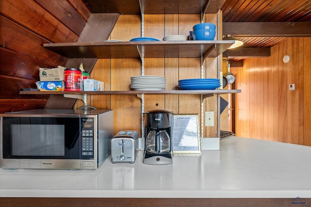 interior details featuring beam ceiling, wooden walls, and wooden ceiling