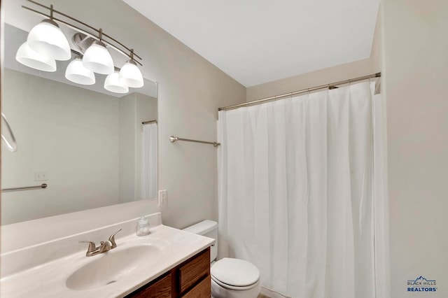 bathroom with vanity, a shower with curtain, and toilet