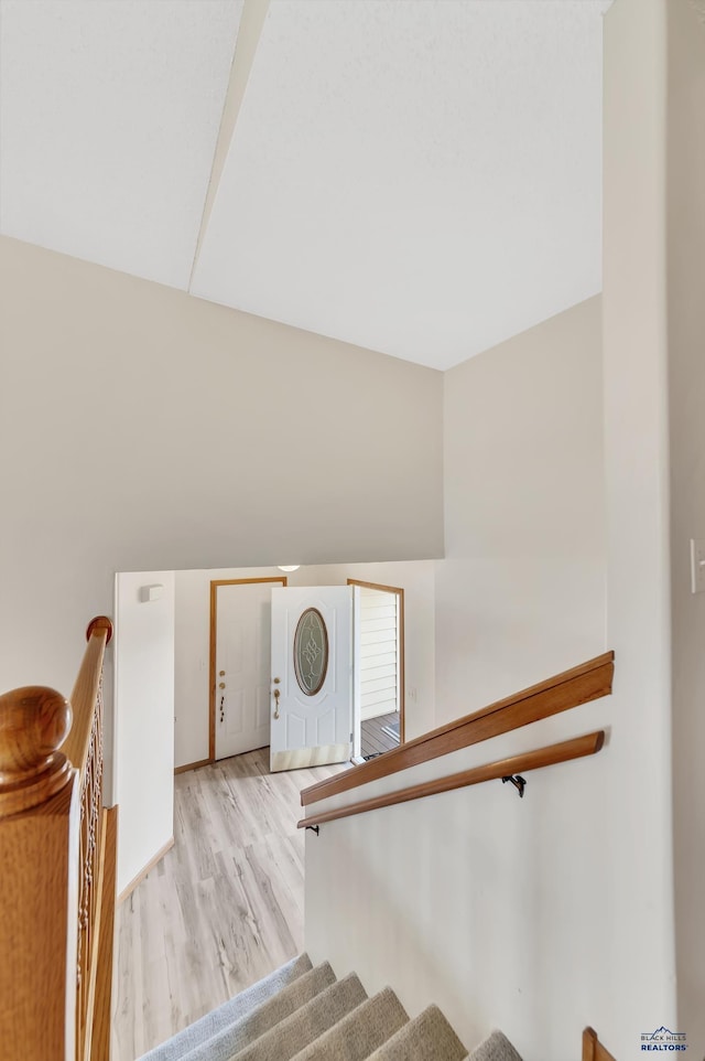 staircase featuring wood-type flooring